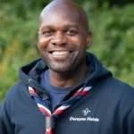 Dwayne Fields, adventurer, TV presenter, and Chief Scout congratulates Thamesmead volunteers