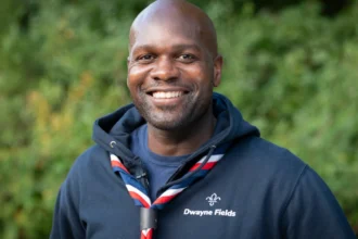 Dwayne Fields, adventurer, TV presenter, and Chief Scout congratulates Thamesmead volunteers